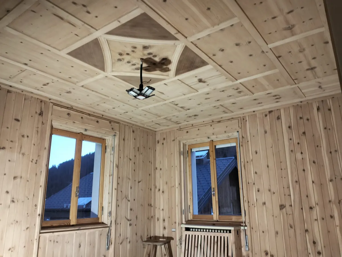 Stube mit Kassettendecke und geschnitzter Rosette in der Mitte, Wände mit hellem Täfer